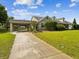 Charming single-Gathering home with a long driveway, a two-car carport, and a well-maintained front lawn at 10318 Piper Dr, New Port Richey, FL 34654