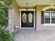Elegant double front doors with glass inserts and decorative accents create a welcoming entrance at 10318 Piper Dr, New Port Richey, FL 34654