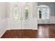 Elegant double front doors with decorative glass inserts and gleaming hardwood floors at 10318 Piper Dr, New Port Richey, FL 34654