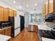 Spacious kitchen boasts wood cabinets, stainless steel appliances, and seamless countertop at 10318 Piper Dr, New Port Richey, FL 34654