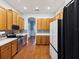 Modern kitchen featuring wood cabinets, white countertops, and stainless steel appliances at 10318 Piper Dr, New Port Richey, FL 34654