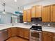 Beautiful kitchen with wood cabinetry, white countertops, and stainless steel appliances at 10318 Piper Dr, New Port Richey, FL 34654