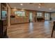 A large kitchen and meeting room with neutral walls and floors is brightly lit with natural and recessed lighting at 10318 Piper Dr, New Port Richey, FL 34654