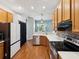 Well-equipped kitchen featuring modern appliances, wood cabinets and white countertops at 10318 Piper Dr, New Port Richey, FL 34654