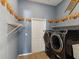 Efficient laundry room with modern washer and dryer set and ample shelving for storage solutions at 10318 Piper Dr, New Port Richey, FL 34654