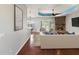 Bright living room with a stone fireplace and wood floors, creating a warm and welcoming atmosphere at 10318 Piper Dr, New Port Richey, FL 34654