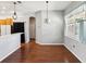 Inviting living room with wood floors, modern lighting, and a view of the open kitchen at 10318 Piper Dr, New Port Richey, FL 34654