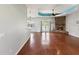 Spacious living room featuring a stone fireplace, wood floors, and a ceiling fan at 10318 Piper Dr, New Port Richey, FL 34654
