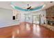 Spacious living room with a stone fireplace, wood floors, and an open layout, perfect for entertaining and relaxation at 10318 Piper Dr, New Port Richey, FL 34654
