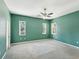 This bedroom includes three windows and a ceiling fan at 10318 Piper Dr, New Port Richey, FL 34654
