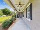Long open porch with ceiling fans and decorative columns at 10318 Piper Dr, New Port Richey, FL 34654