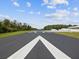 Wide-angle shot of the runway with clear markings, ensuring safe takeoffs and landings at 10318 Piper Dr, New Port Richey, FL 34654