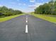 Clear view of the runway with crisp white markings for guidance during aircraft operations at 10318 Piper Dr, New Port Richey, FL 34654