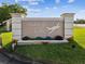 Welcoming Hidden Lake sign with lush landscaping and flowers at 10318 Piper Dr, New Port Richey, FL 34654