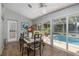 Bright sunroom features a dining area with a view of the pool and outdoor area at 10372 Fairchild Rd, Spring Hill, FL 34608