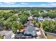 An aerial view of a charming two-story home with a well-maintained yard and mature trees in a quiet neighborhood at 10423 Ashley Oaks Dr, Riverview, FL 33578