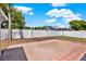 A backyard featuring a large brick patio, white vinyl fence, and lush landscaping under a bright blue sky at 10423 Ashley Oaks Dr, Riverview, FL 33578