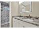 Bright bathroom featuring dual sinks, granite countertops, and a marble-tiled shower with updated hardware at 10423 Ashley Oaks Dr, Riverview, FL 33578