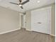 Bedroom features closet doors, neutral walls, and wood-look flooring at 10423 Ashley Oaks Dr, Riverview, FL 33578