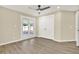 This bedroom features a ceiling fan, double closet and sliding glass doors at 10423 Ashley Oaks Dr, Riverview, FL 33578
