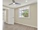 Bedroom features wood-look flooring, window, and ceiling fan at 10423 Ashley Oaks Dr, Riverview, FL 33578