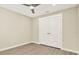 Bedroom with wood-look floors and white bi-fold closet doors at 10423 Ashley Oaks Dr, Riverview, FL 33578