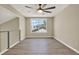 Bonus room features wood-look floors, a ceiling fan, and a large window at 10423 Ashley Oaks Dr, Riverview, FL 33578