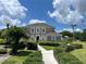 Beautiful two-story home with manicured landscaping, a lush lawn, and a welcoming pathway to the front door at 10423 Ashley Oaks Dr, Riverview, FL 33578