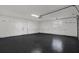 Spacious garage with freshly epoxied floor, offering ample storage and parking at 10423 Ashley Oaks Dr, Riverview, FL 33578