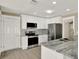 Stylish kitchen with white cabinets, stainless steel appliances, and a functional layout at 10423 Ashley Oaks Dr, Riverview, FL 33578