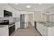 Well-equipped kitchen with stainless steel appliances, stylish cabinets, and an open design for easy flow at 10423 Ashley Oaks Dr, Riverview, FL 33578