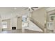 Inviting living room with a modern staircase, fireplace, and an open-concept design to the kitchen at 10423 Ashley Oaks Dr, Riverview, FL 33578