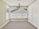 Bright room with large windows, modern lighting fixtures, and stylish flooring at 10423 Ashley Oaks Dr, Riverview, FL 33578