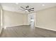 Spacious room with ceiling fan, stylish floors, and an open doorway at 10423 Ashley Oaks Dr, Riverview, FL 33578