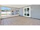 Enclosed sunroom with tiled floor and view of the backyard at 10423 Ashley Oaks Dr, Riverview, FL 33578