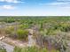 An aerial shot shows the home from a distance with a long driveway that leads to a two car garage and the house at 10531 Lakeview Dr, New Port Richey, FL 34654