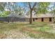 Expansive backyard view features a screened pool area, offering a serene outdoor living space with room to enjoy nature at 10531 Lakeview Dr, New Port Richey, FL 34654