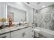 Modern bathroom featuring granite countertops, updated fixtures, and stylish vanity lighting and tub at 10531 Lakeview Dr, New Port Richey, FL 34654