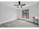 Bedroom with window, ceiling fan, and tile floors at 10531 Lakeview Dr, New Port Richey, FL 34654