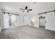 Bedroom with sliding barn doors that open to bathroom and closet space, featuring tile flooring at 10531 Lakeview Dr, New Port Richey, FL 34654