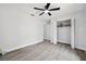 Bright bedroom with gray flooring, ceiling fan, and a large closet offering ample storage at 10531 Lakeview Dr, New Port Richey, FL 34654