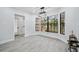 Dining area features large windows with an outdoor view and decorative lighting at 10531 Lakeview Dr, New Port Richey, FL 34654