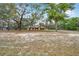 Spacious front yard with mature trees leads to a charming home with an attached garage, exuding curb appeal at 10531 Lakeview Dr, New Port Richey, FL 34654