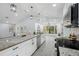 Bright kitchen showcasing a large granite island, stainless steel appliances, and stylish pendant lighting at 10531 Lakeview Dr, New Port Richey, FL 34654
