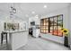 Bright kitchen with white cabinets, granite countertops and stainless steel appliances and a view to the front yard at 10531 Lakeview Dr, New Port Richey, FL 34654