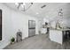 Open concept kitchen features a stainless steel refrigerator and updated cabinets and countertops at 10531 Lakeview Dr, New Port Richey, FL 34654