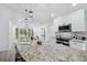 Bright kitchen featuring a spacious granite island and stainless steel appliances at 10531 Lakeview Dr, New Port Richey, FL 34654