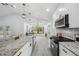 Bright kitchen showcasing a large granite island, stainless steel appliances, and stylish pendant lighting at 10531 Lakeview Dr, New Port Richey, FL 34654