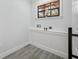 Bright laundry room featuring modern gray tile flooring and a convenient window for natural light at 10531 Lakeview Dr, New Port Richey, FL 34654