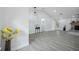 Open-concept living room featuring gray wood-look tile and high ceilings at 10531 Lakeview Dr, New Port Richey, FL 34654